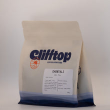 Load image into Gallery viewer, A bag of Clifftop Coffee Roasters Chontali medium roast whole bean coffee, in a cream-colored stand-up pouch with a blue and white gradient at the bottom and a white label on the front.
