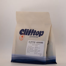 Load image into Gallery viewer, A bag of Clifftop Top Espresso coffee from Clifftop Coffee Roasters, featuring a cream-colored bag with blue branding and a white label, set against a plain light gray background.

